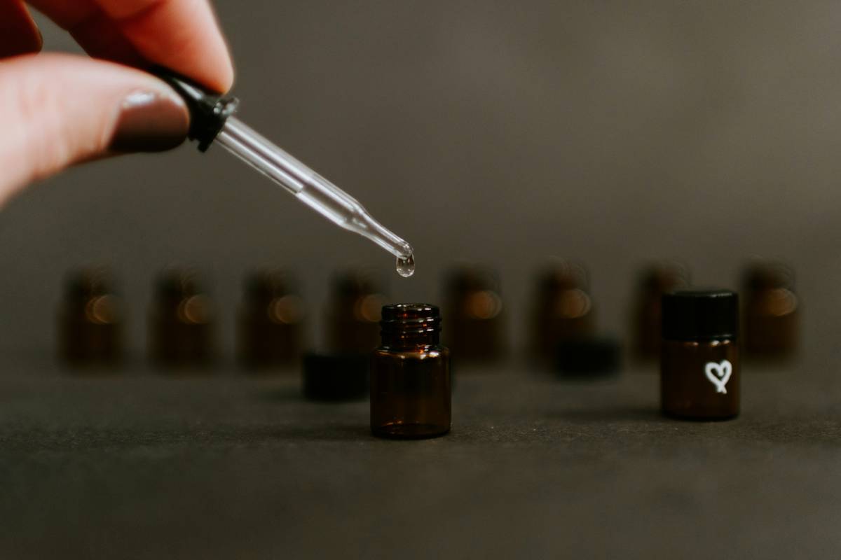 Close-up of a man applying beard oils with jojoba to his beard, showing smooth texture and healthy skin underneath